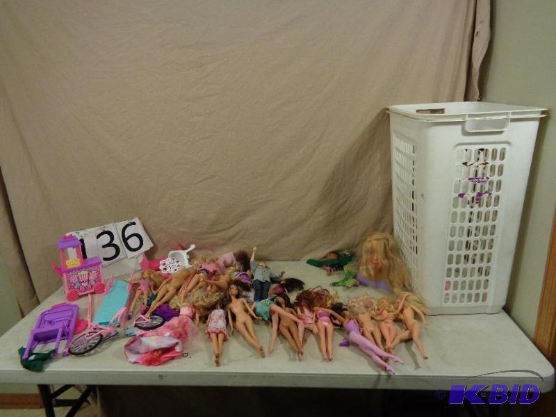 lot 136 image: Laundry basket full of Barbies and accessorie...