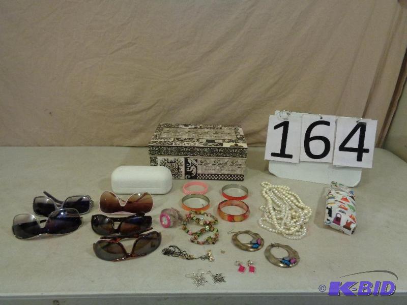 lot 164 image: Lot of Sunglasses (one marked Prada), Oakley ...