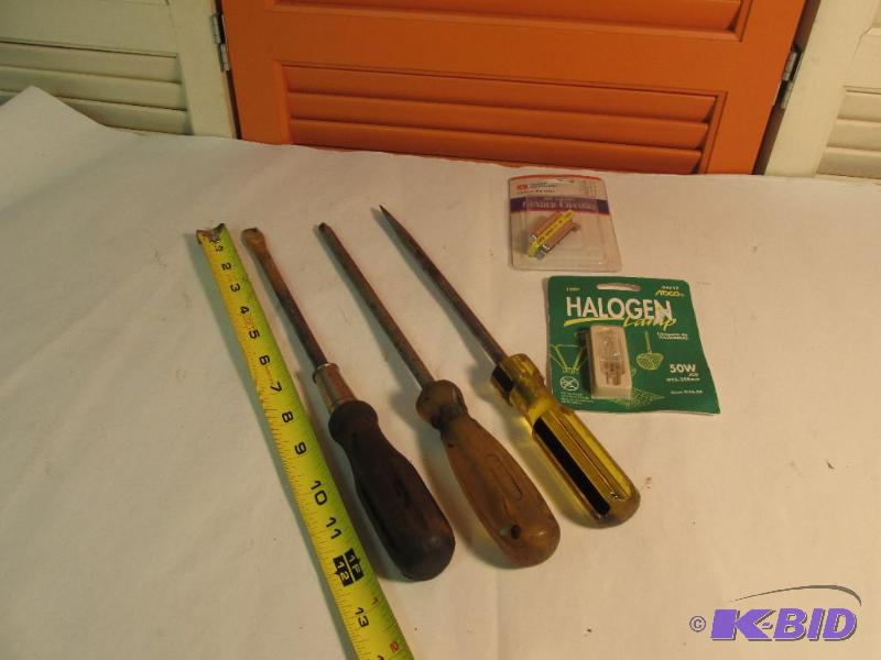 3 Large Screw Drivers, an older Halogen light, and an old part
