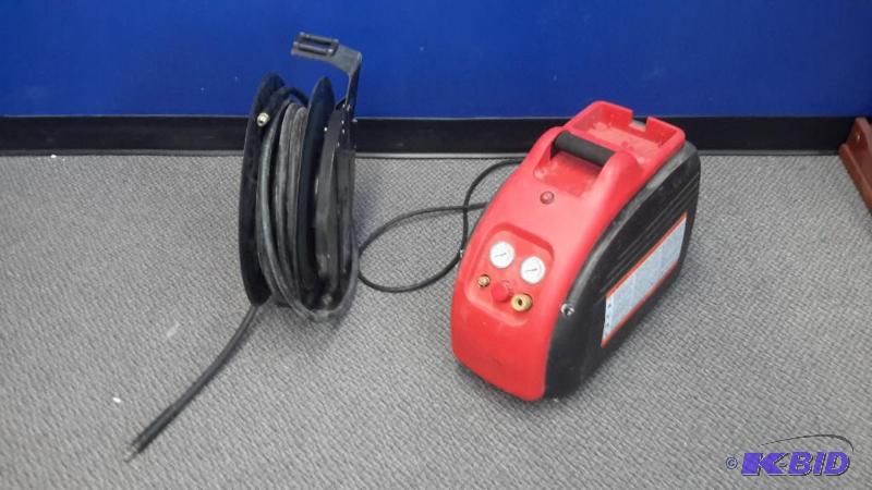 lot 87 image: Air compressor and hose reel
