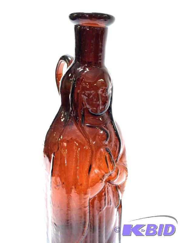 lot 21 image: Vintage circa 1920s Amber Glass Madonna Figure Bottle with Applied Handle