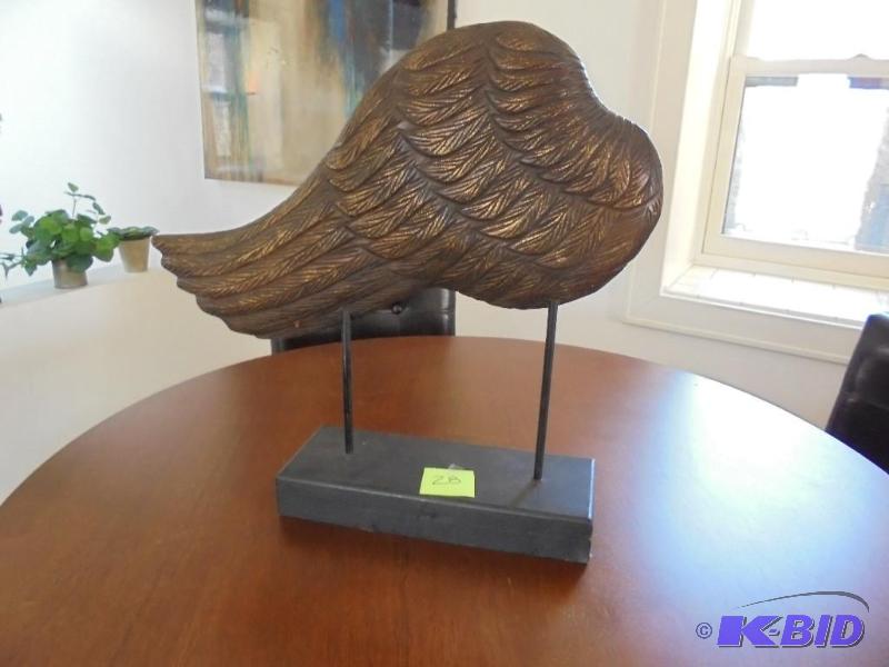Large decorative carved wing on pedestal, hom...