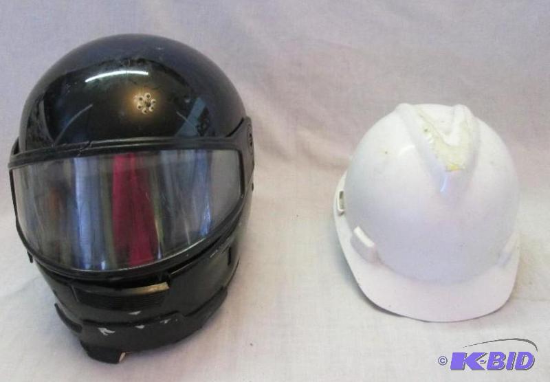 used black motorcycle helmet, and white hard ...