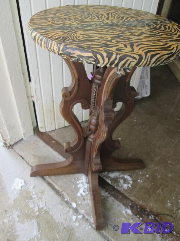 very ornate wood table base with zebra patter...