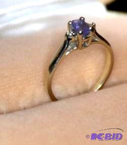 lot 77 image: 10k GOLD and diamond ring with purple stone...
