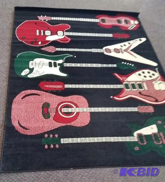lot 14 image: Unique Guitar Theme Area Rug.  Gently Used.  Blacks Reds and Greens.