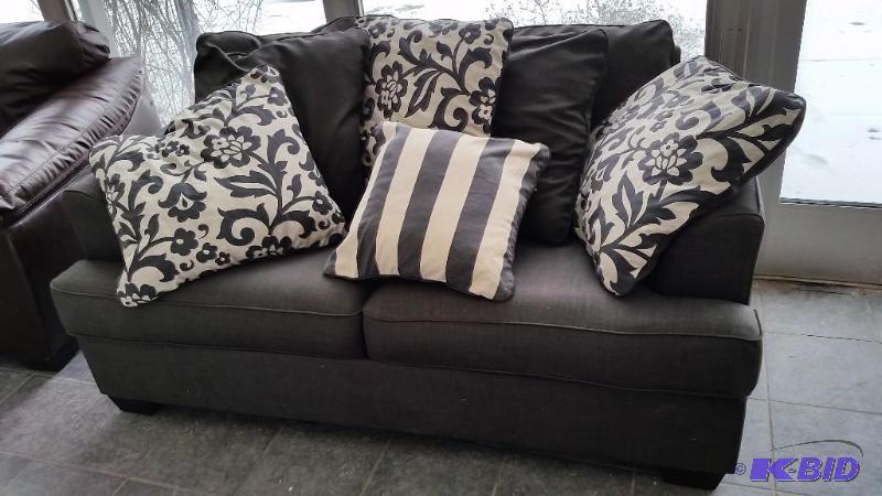 lot 5 image: Ashley Gray Fabric Love Seat and Decorative Pillows.  Gently Used Very Clean