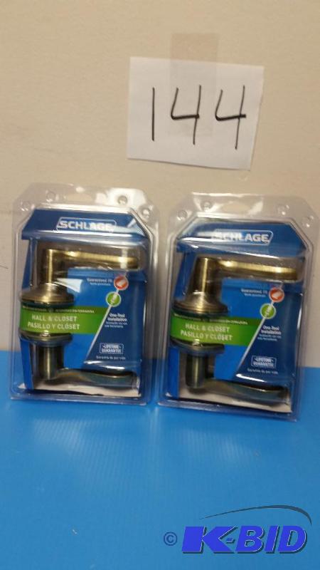 lot 144 image: set of 2 new Schlage Flair Antique Brass Hall and Closet Lever