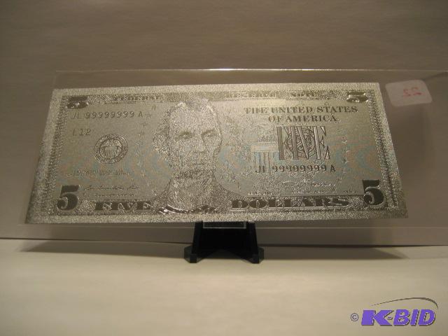 lot 22 image: 5 DOLLAR SILVER BILL, PURE .999 SILVER PRESSED ON TO A SPECIAL POLYCARBONATE TO MAKE THIS BILL