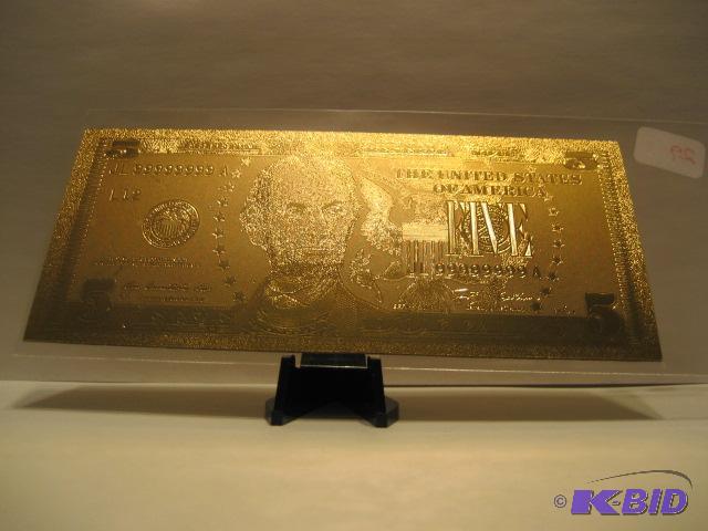 lot 29 image: 5 DOLLAR GOLD BILL, PURE 24K GOLD PRESSED ON TO A SPECIAL POLYCARBONATE TO MAKE THIS BILL