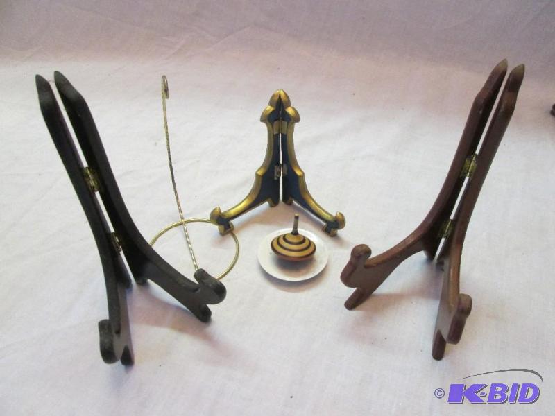 Plate easels and a small wood top on a saucer...