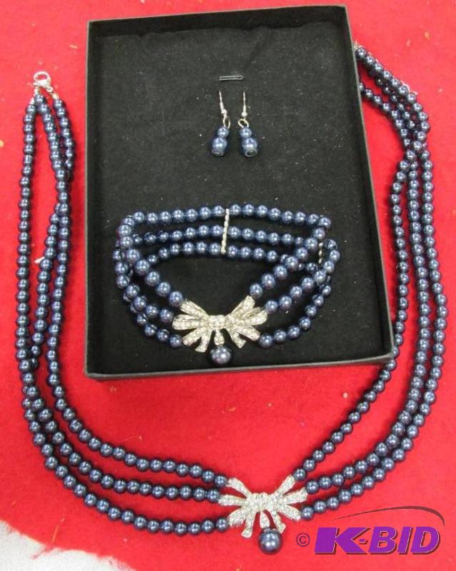 lot 37 image: Blue beads with a decorative piece in the mid...