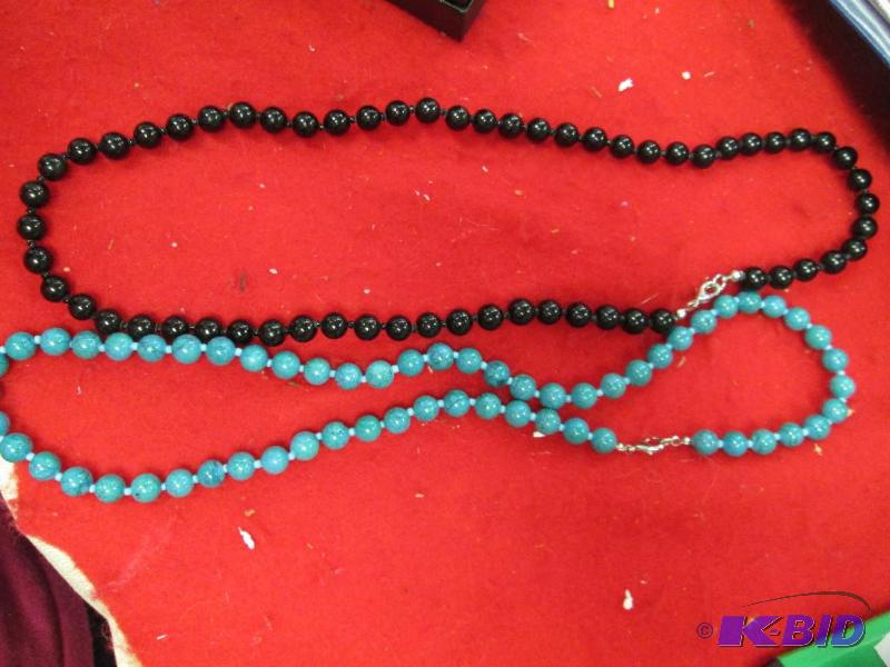 lot 62 image: Black beads and greenish...
