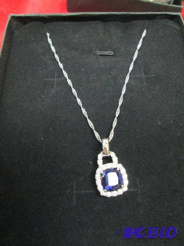 lot 81 image: Necklace with a blue stone fake diamond aroun...