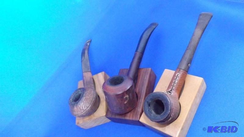 No markings (natural wood looking pipe), John...