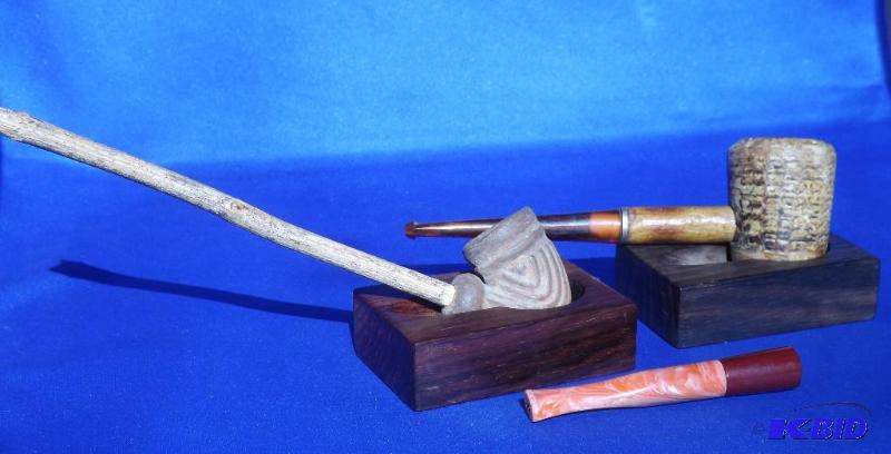 one clay pipe with wooden reed stem, one corn...