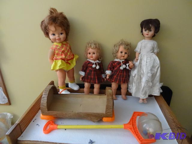 Box of Misc Dolls. Plastic Rocking Cradle....