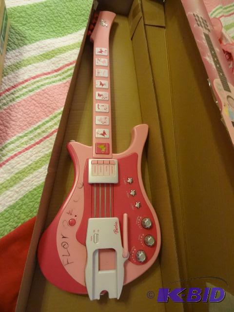 lot 24 image: Disney princess guitar. Battery operated...