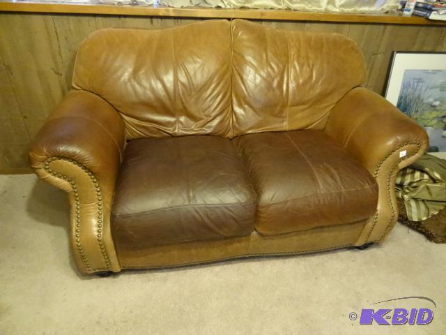 lot 32 image: Leather trend real leather love seat. No rips...