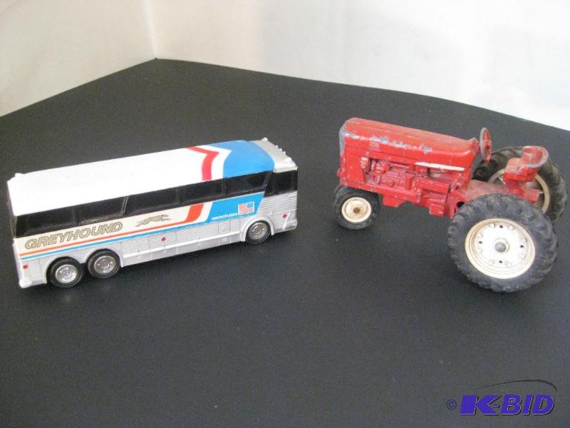 lot 15 image: Vintage Greyhound Toy Bus and Red Tractor...