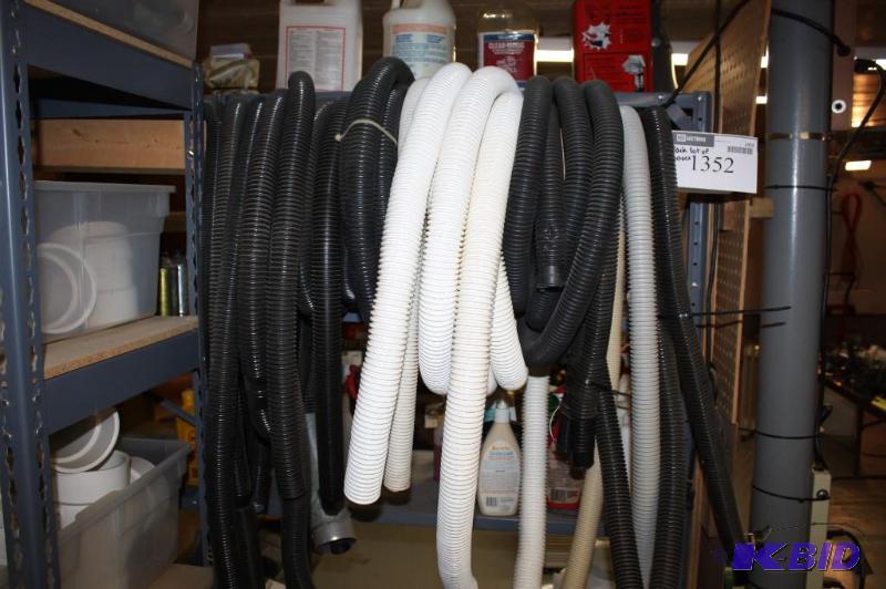 lot 1352 image: Rack Lot of hoses Includes White and Black Hoses and More.
