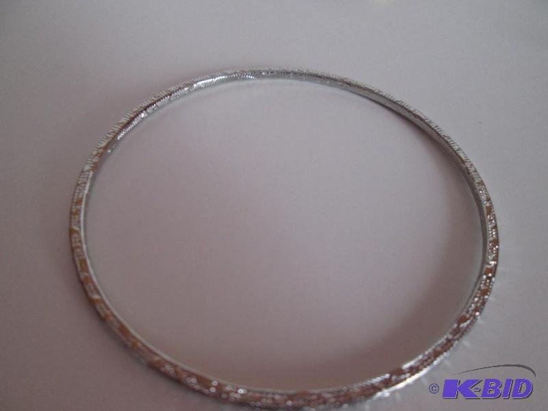 lot 354 image: sliver metal braclet with design outlining it...