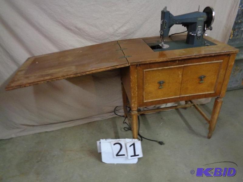 lot 21 image: Old Kenmore sewing machine with wood cabinet....