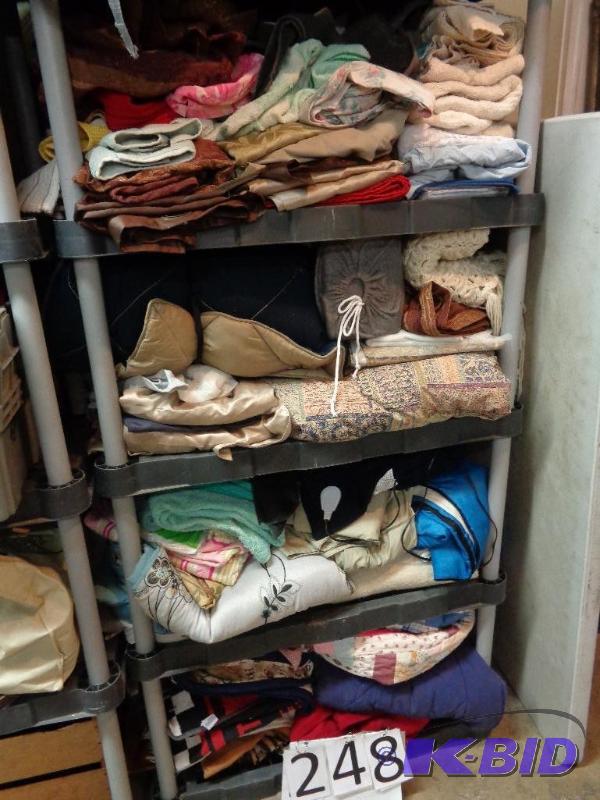 lot 248 image: 4 shelves of linens. Comforters, blankets, sh...