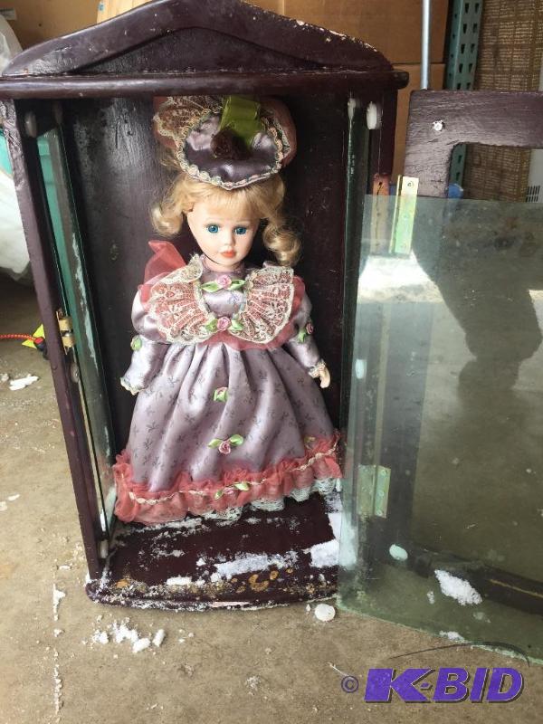 lot 42 image: Porcelain doll, wood and glass case is damage...