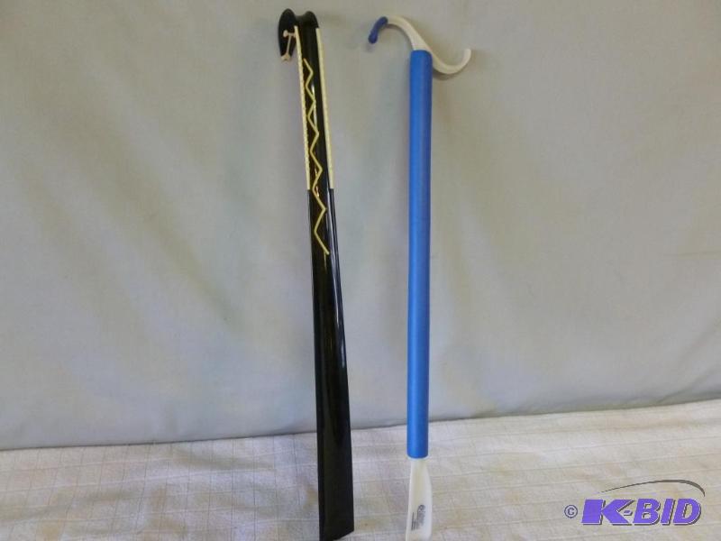 lot 125 image: Lot of two large shoe horns that measure abou...