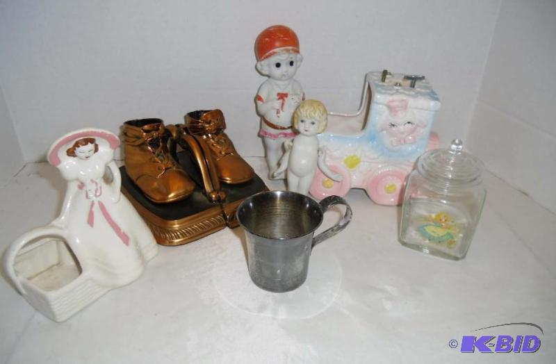lot 29 image: Sweet Baby  Bronze Shoe Bookends  Musical Train Planter  2 Bisque Dolls  Silver Childs Cup 