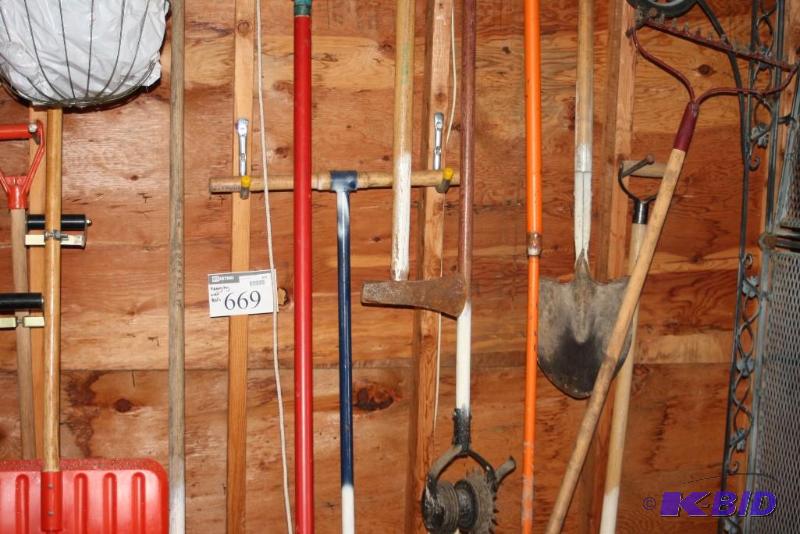 lot 669 image: Wall Lot Including Shovels Metal Rakes Ground Tiller And More.