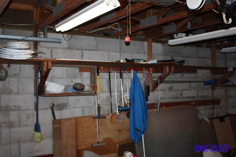 lot 678 image: Contents of Shelves & Below Including Plastic Jugs wSpouts & Caps Stop Sign Water Cooler And Mo