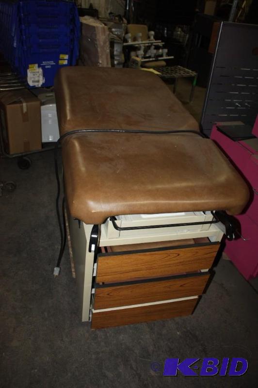 lot 8 image: Hamilton E Series Exam Table wStorage Drawers & Padded Rests Fold-Out Foot Rest 27 x 54 x 36.