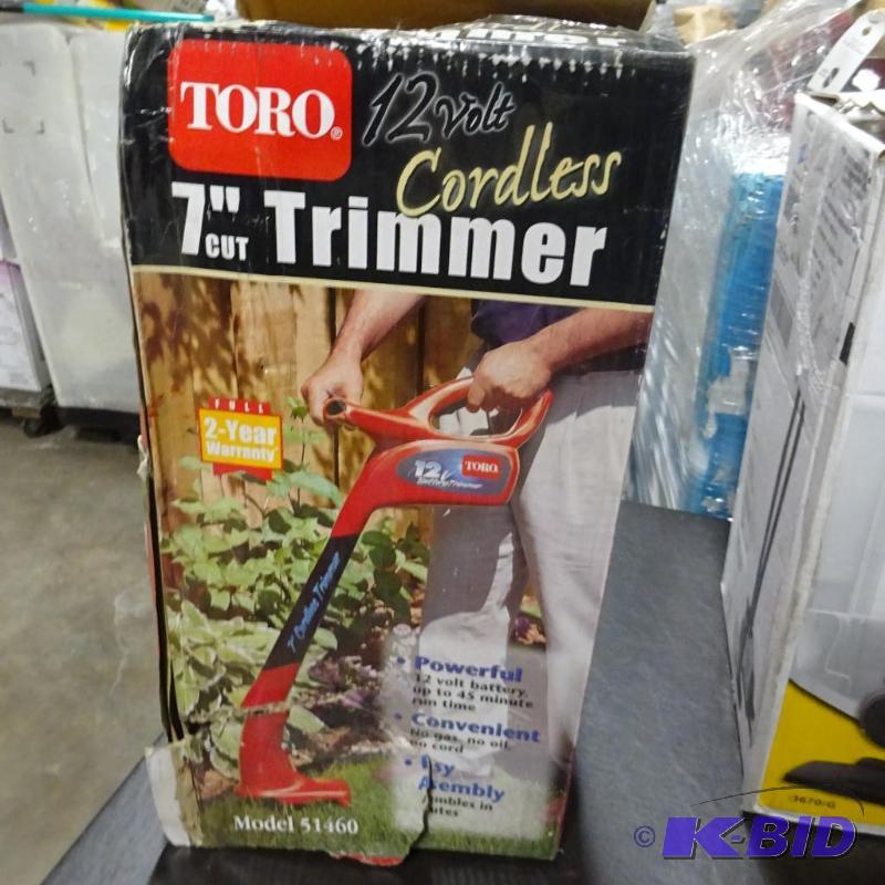 lot 84 image: New Toro 7in cordless trimmer. Ripped box oth...