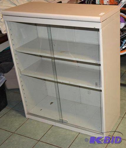 lot 52 image: Display case with glass doors 36x44x15"....