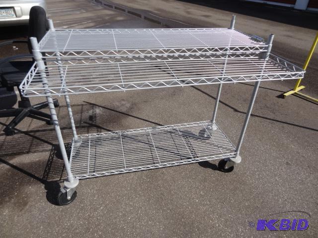 lot 51 image: Wire shelf unit. On wheels. 48 x 18 x 40...