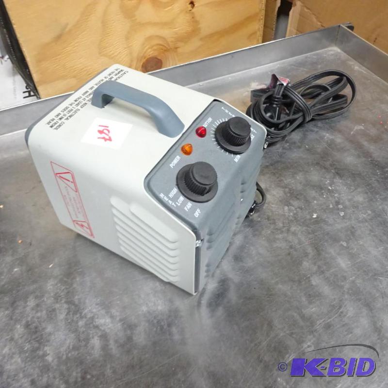 lot 187 image: New Optimus brand portable space heater. Miss...