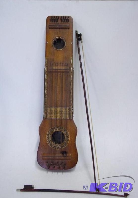 lot 1 image: Antique Ukelin with bow...