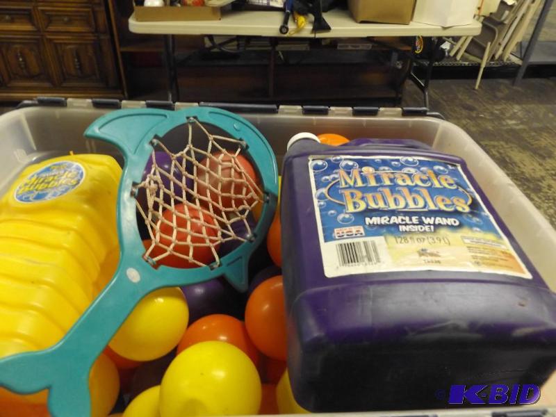 lot 82 image: Tote of balls and a jug of bubbles...