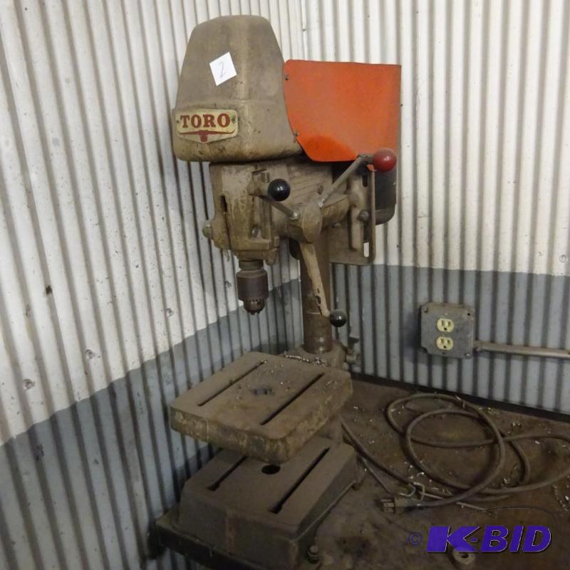 lot 2 image: Toro Drill Press. Bolted to Bench. 12 "...