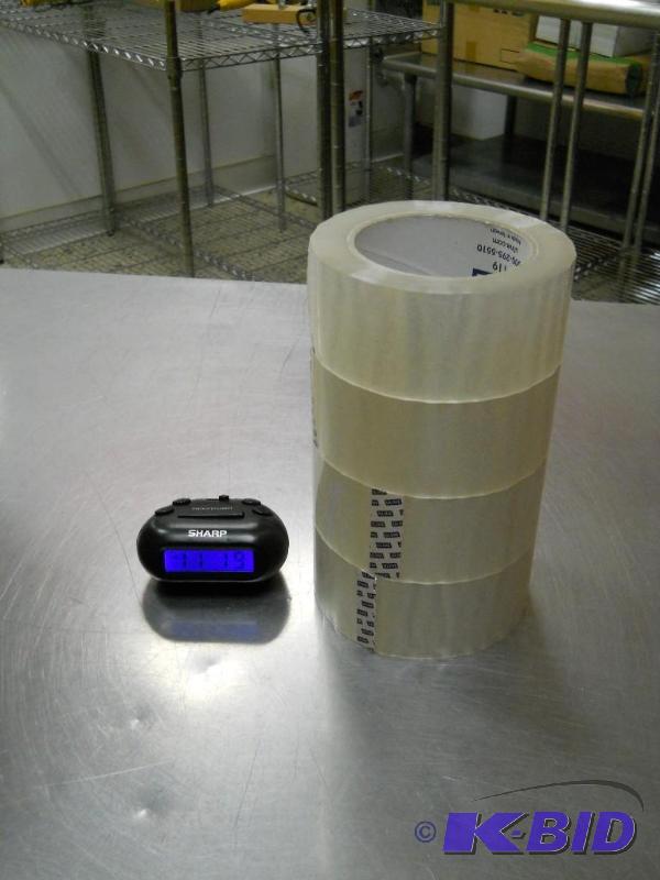 4 Rolls of Packing Tape and a Small Alarm Clock.
