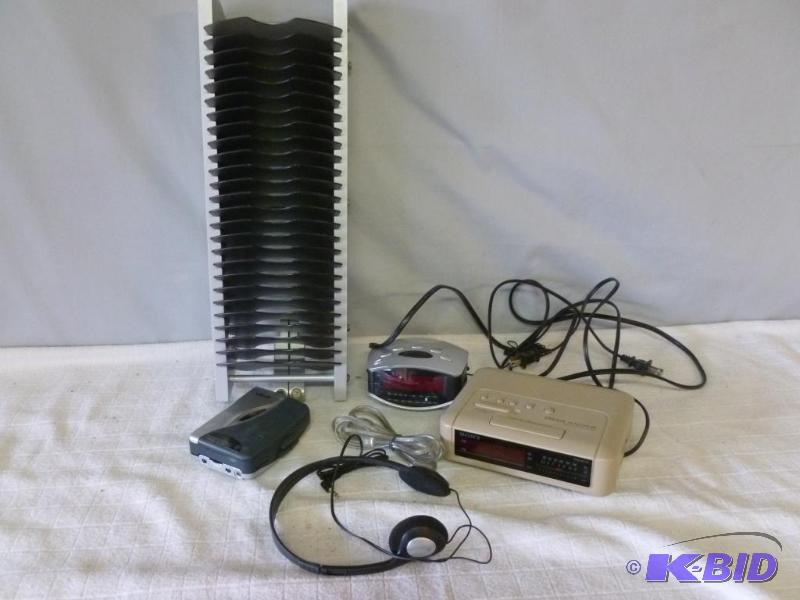lot 111 image: Lot of two alarm clocks, walkman and cd rack....