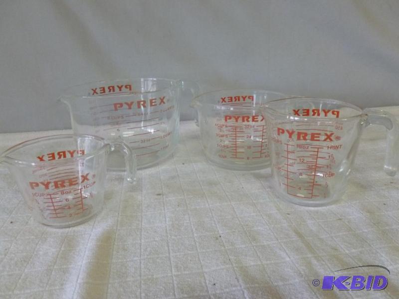 lot 72 image: A Set Of Four Pyrex glass measuring container...
