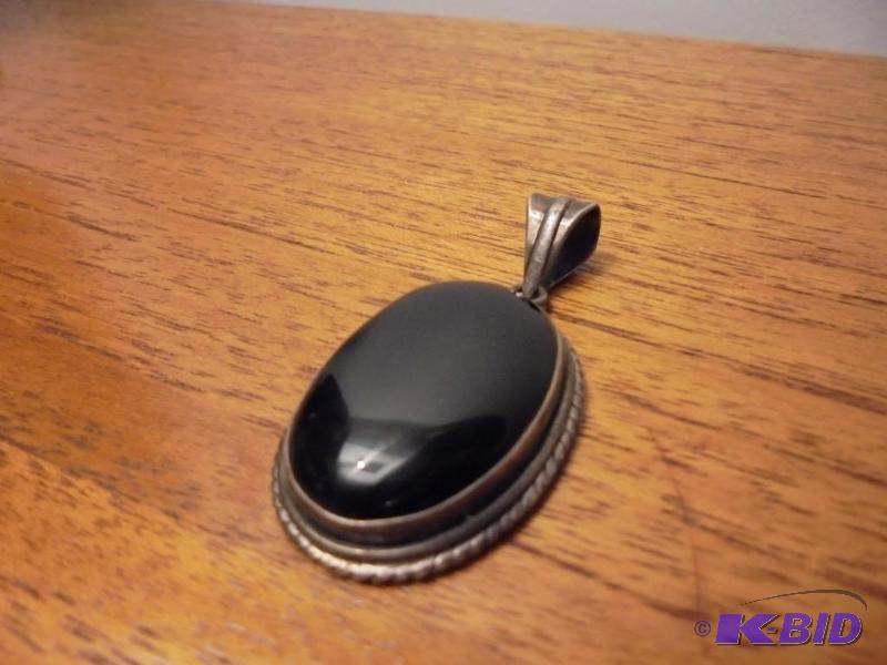 lot 27 image: Large Sterling Silver and black Onyx pendant....