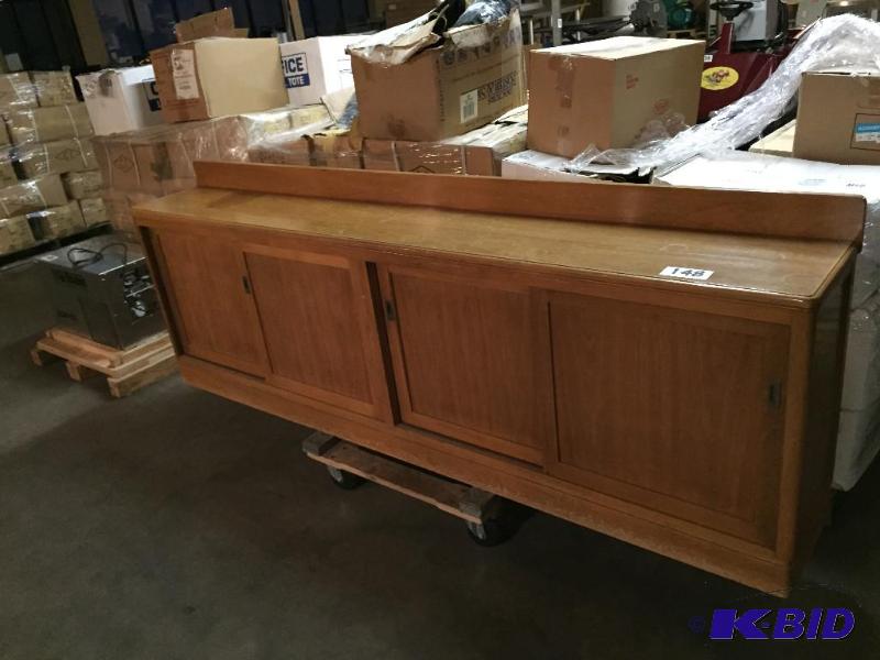 lot 148 image: Long wooden credenza with sliding doors....