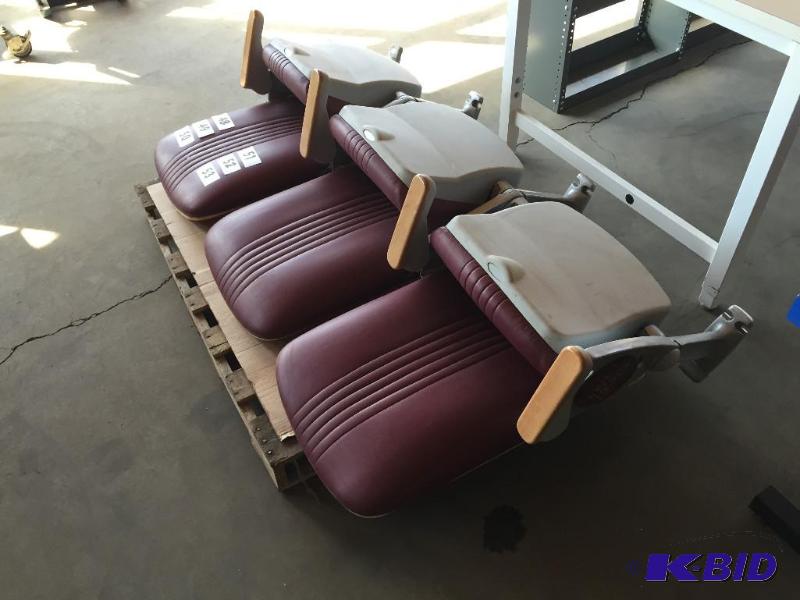 lot 49 image: Bank of 3 maroon stadium seats with U of M lo...
