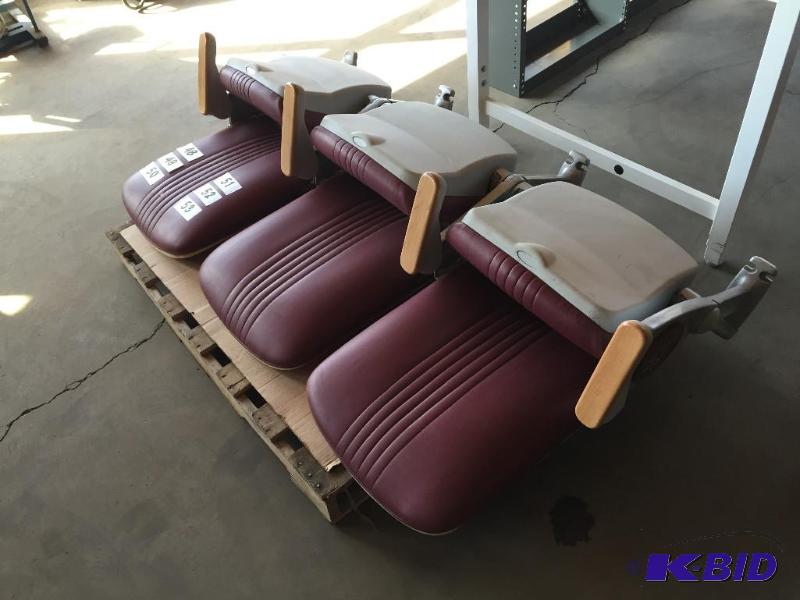 lot 50 image: Bank of 3 maroon stadium seats with U of M lo...