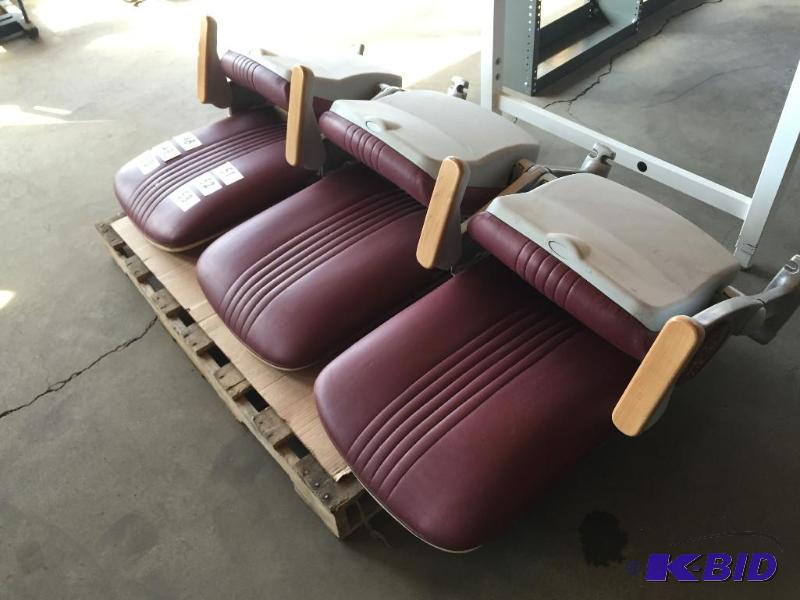 lot 52 image: Bank of 3 maroon stadium seats with U of M lo...