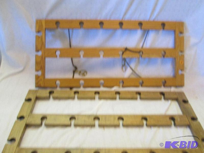 2 wooden slotted frames one has chains to han...